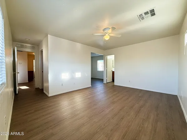 a view of empty room with wooden floor