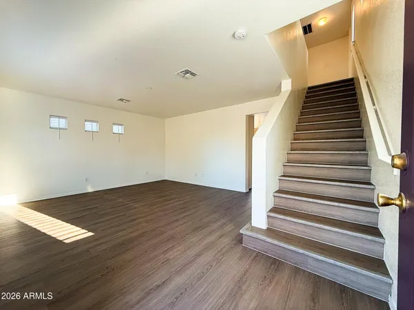 a view of entryway and hall with wooden floor
