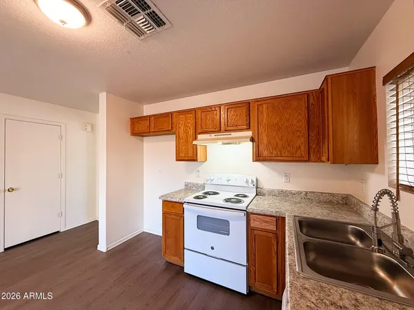 a kitchen with stainless steel appliances granite countertop a sink stove and cabinets