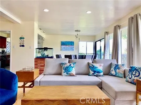 a living room with furniture and large windows