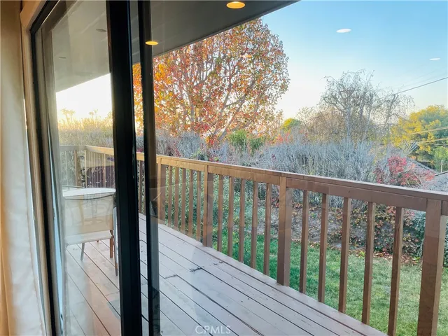 a view of a balcony with wooden floor