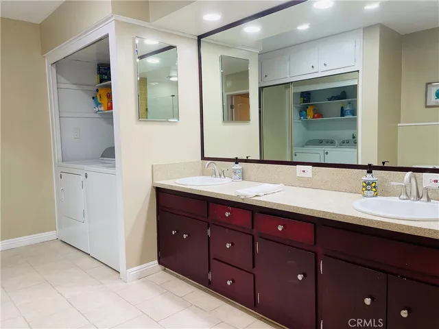 a bathroom with double vanity sink and a mirror