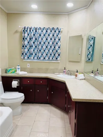 a bathroom with a granite countertop sink a toilet and a bathtub