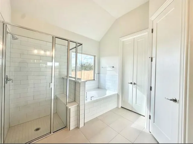 a bathroom with a bathtub and a shower