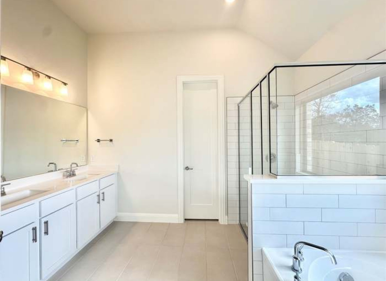 528 Tubman Drive Kyle, TX 78640 - Photo 10 of 27 a spacious bathroom with a double vanity sink a mirror and next to a window