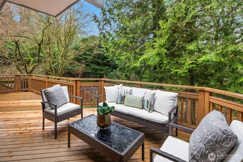 a roof deck with couches and wooden floor