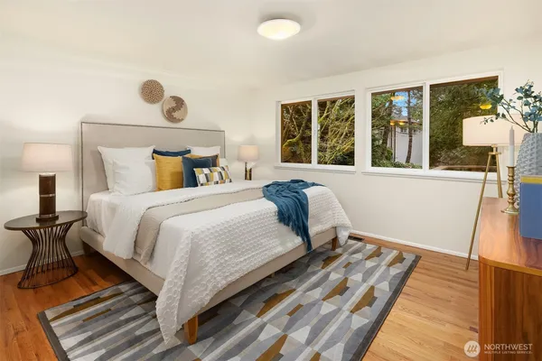a bedroom with a bed and a large window