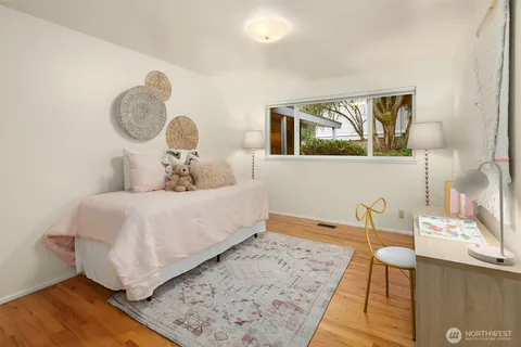a bed room with a bed and a painting on the wall