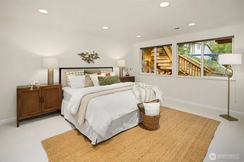 a bedroom with a bed and glass window
