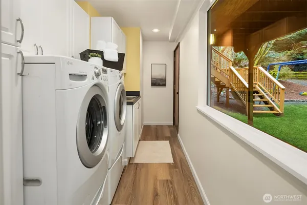 a view of a hallway with washer and dryer