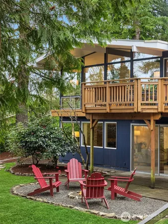 a view of a house with backyard porch and sitting area