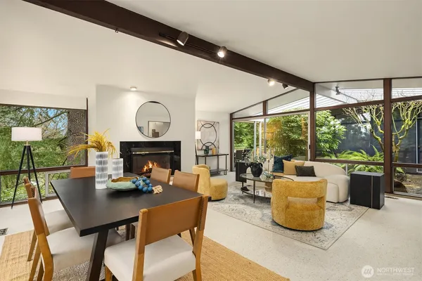 a living room with fireplace furniture and a large window