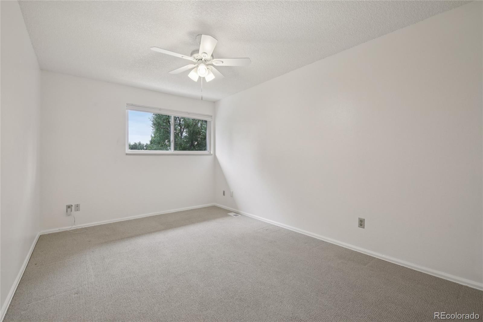 1169 Monroe Drive, Unit B Boulder, CO 80303 - Photo 18 of 32 a view of an empty room with a chandelier fan