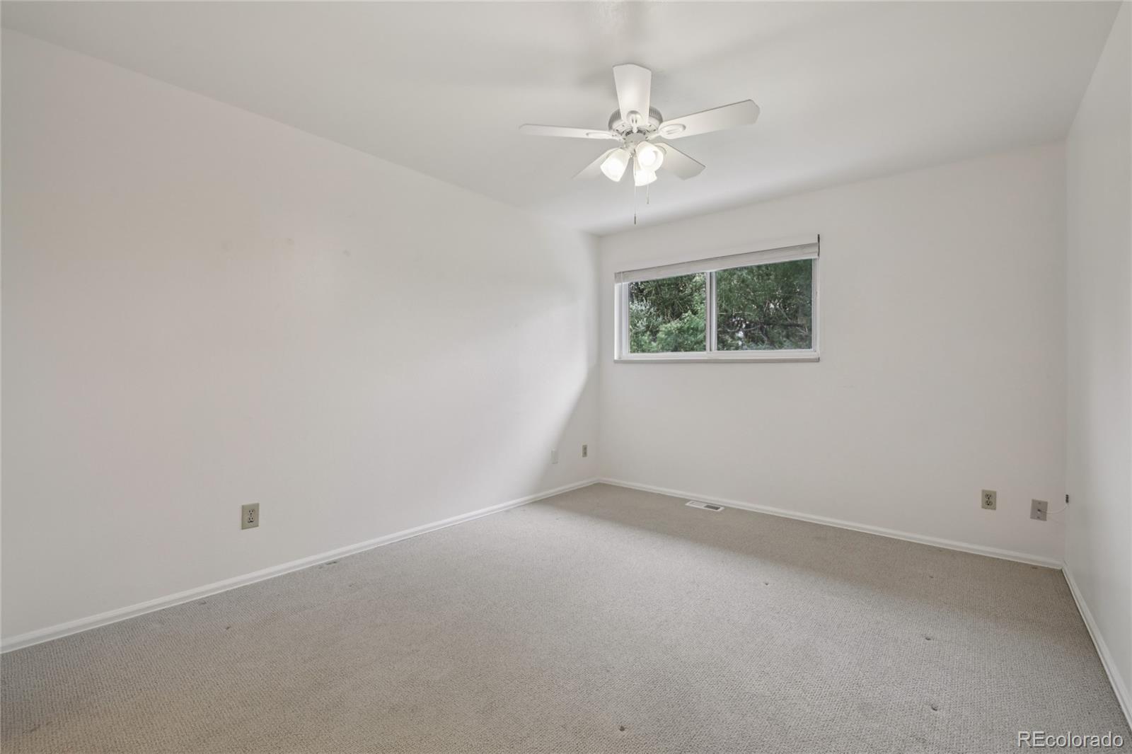 1169 Monroe Drive, Unit B Boulder, CO 80303 - Photo 20 of 32 a view of an empty room with a chandelier fan
