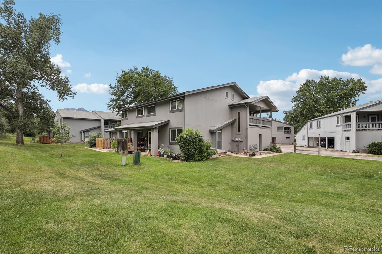 1169 Monroe Drive, Unit B Boulder, CO 80303 - Photo 26 of 32 a view of a house with a big yard and large trees
