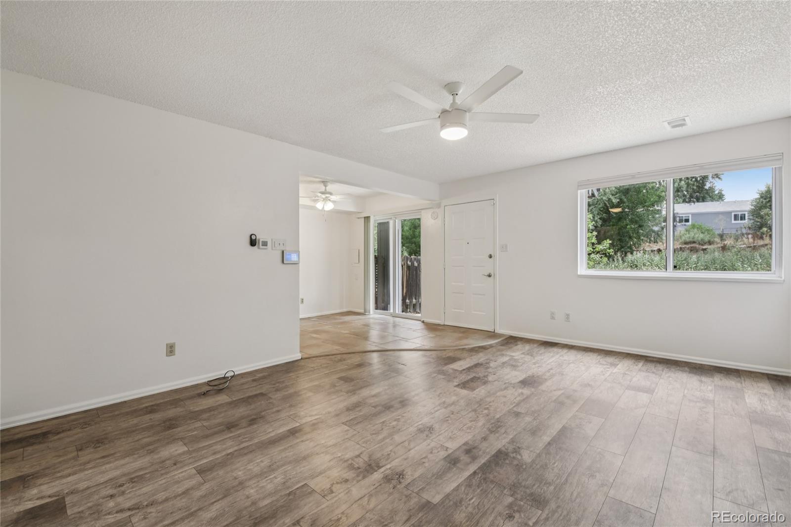 1169 Monroe Drive, Unit B Boulder, CO 80303 - Photo 6 of 32 wooden floor in an empty room with a window