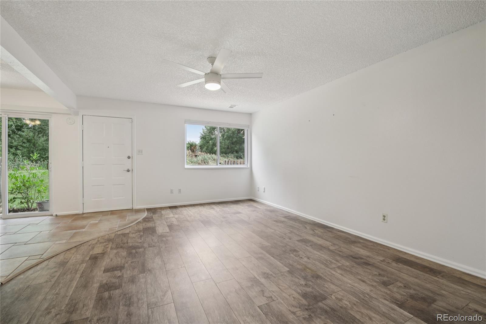 1169 Monroe Drive, Unit B Boulder, CO 80303 - Photo 7 of 32 a view of an empty room with a window and wooden floor