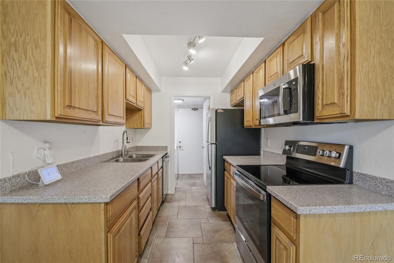1169 Monroe Drive, Unit B Boulder, CO 80303 - Photo 10 of 32 a kitchen with stainless steel appliances granite countertop a sink and cabinets