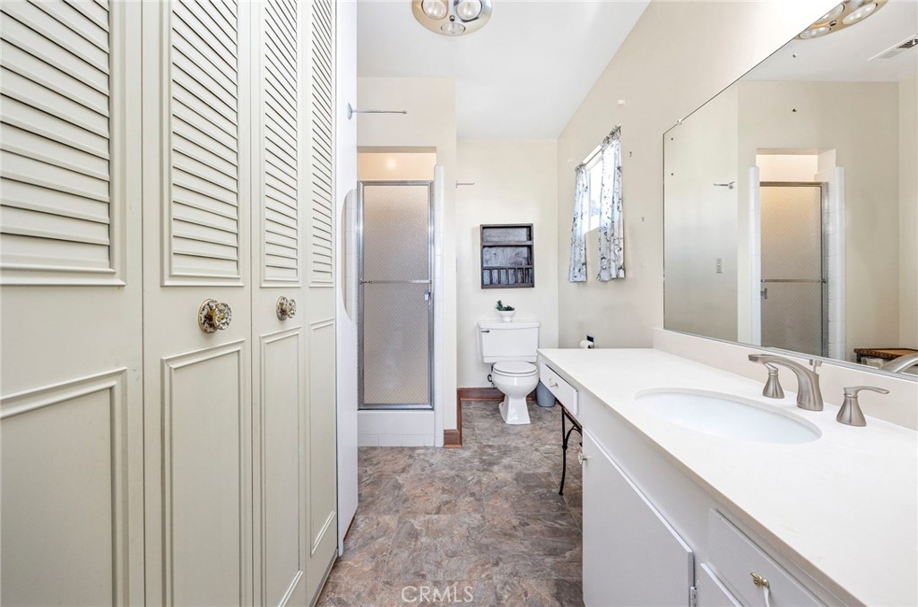 26320 Rim Road Hemet, CA 92544 - Photo 14 of 50 a bathroom with a sink a toilet and shower