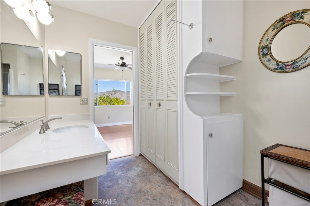 26320 Rim Road Hemet, CA 92544 - Photo 15 of 50 a bathroom with a sink and a mirror