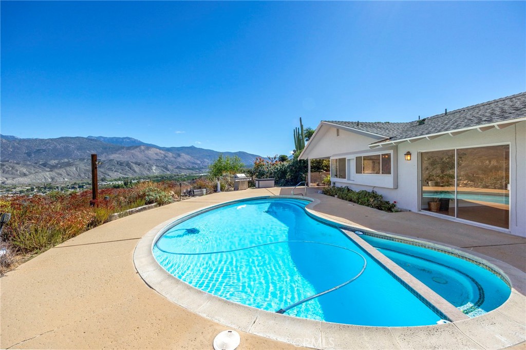 26320 Rim Road Hemet, CA 92544 - Photo 2 of 50 a view of a swimming pool with a lounge chair