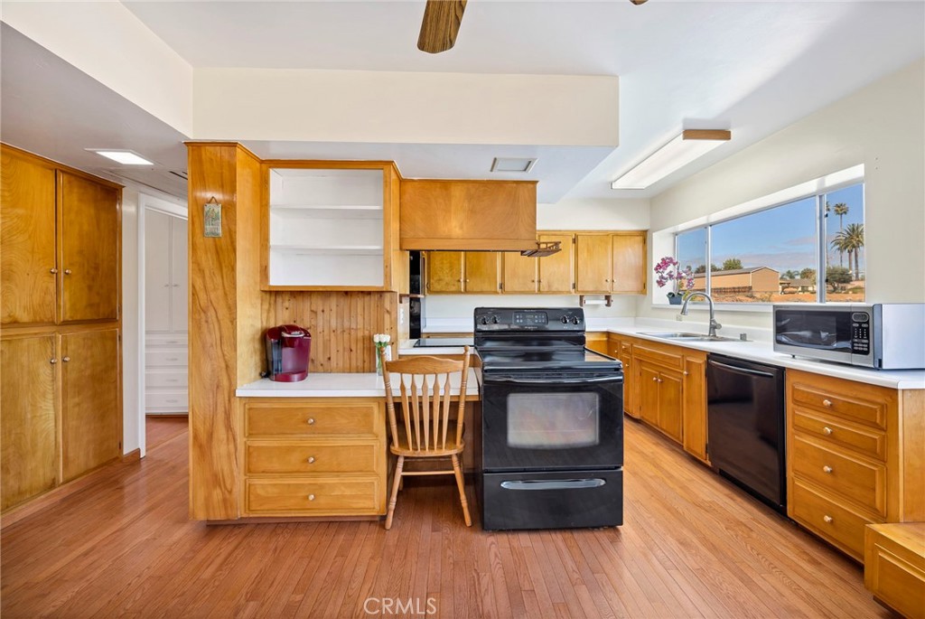 26320 Rim Road Hemet, CA 92544 - Photo 21 of 50 a kitchen with stainless steel appliances granite countertop a stove and a wooden floors