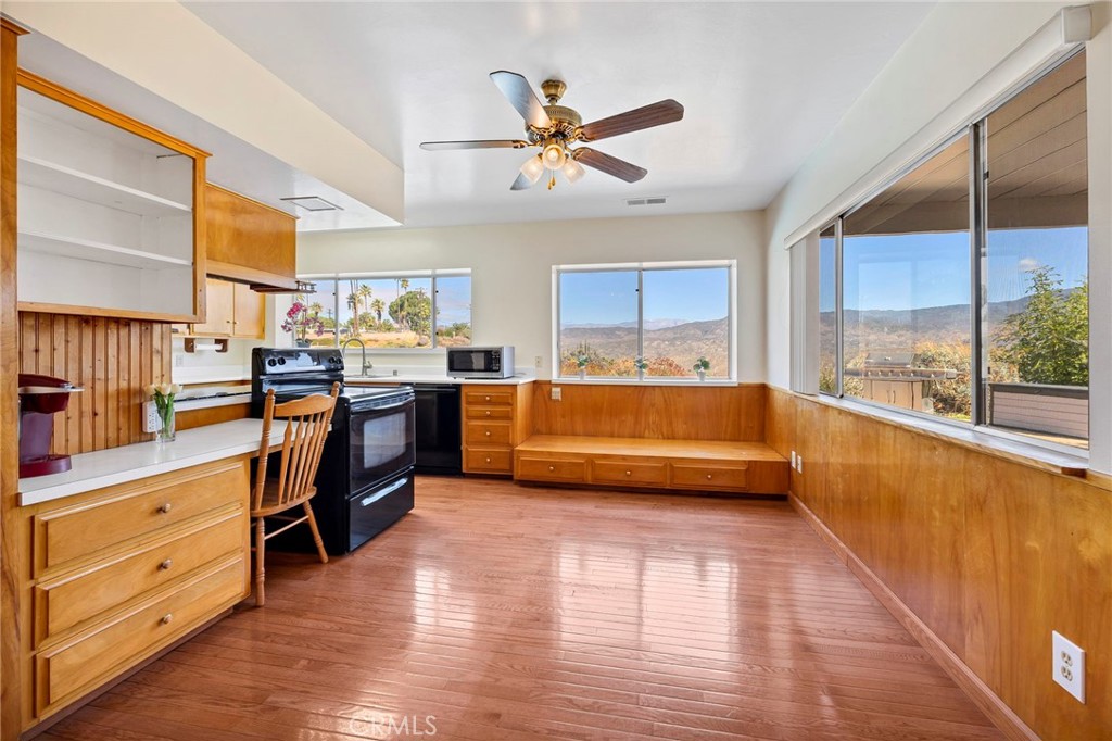 26320 Rim Road Hemet, CA 92544 - Photo 22 of 50 a view of a kitchen with kitchen island a counter top space a sink a wooden floor and a window