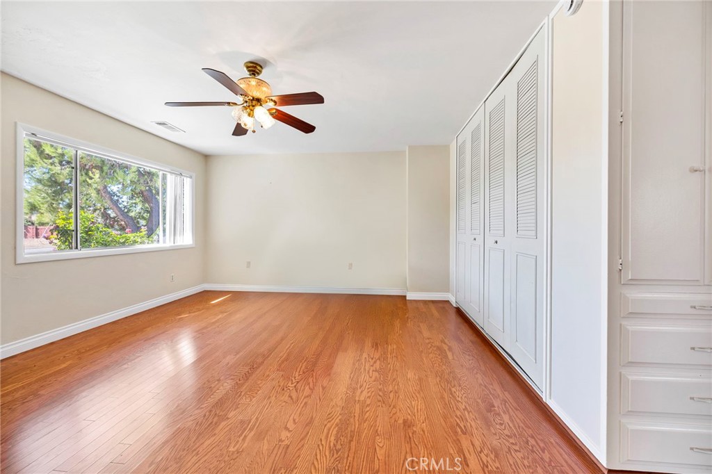 26320 Rim Road Hemet, CA 92544 - Photo 31 of 50 an empty room with wooden floor fan and windows