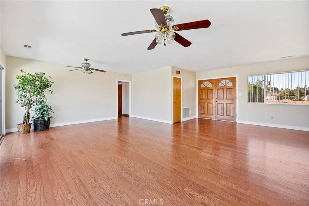 26320 Rim Road Hemet, CA 92544 - Photo 7 of 50 a view of an empty room with wooden floor and a window