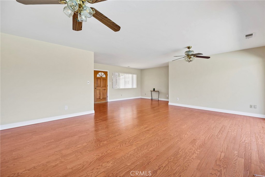 26320 Rim Road Hemet, CA 92544 - Photo 8 of 50 a view of a room with a wooden floor and a ceiling fan