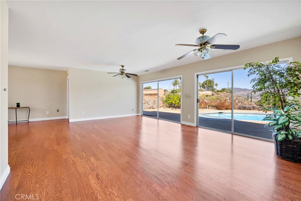 26320 Rim Road Hemet, CA 92544 - Photo 9 of 50 a view of n empty room with window and wooden floor