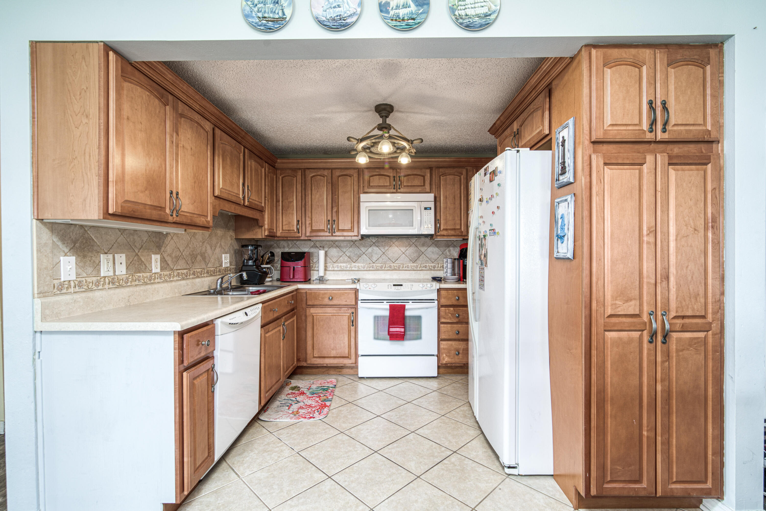 101 Old Ferry Road, Unit 26A Shalimar, FL 32579 - Photo 12 of 61 a kitchen with stainless steel appliances granite countertop a refrigerator and a stove top oven