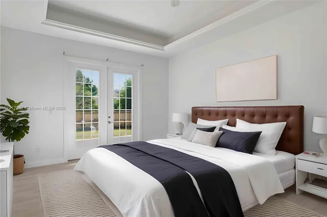 a bedroom with bed and a potted plant