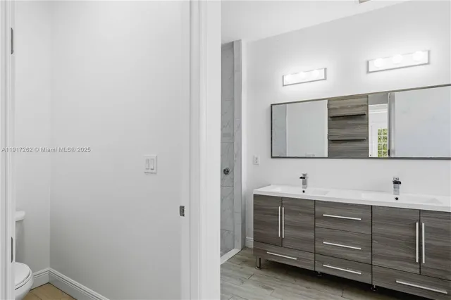a bathroom with a double vanity sink and mirror