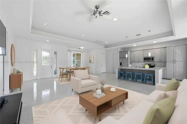 a living room with furniture and view of kitchen