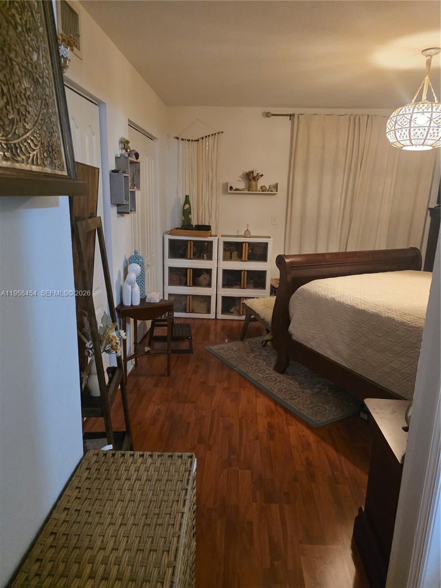 7701 West 36th Avenue, Unit 3 Hialeah, FL 33018 - Photo 13 of 28 a bed room with a bed and a chair