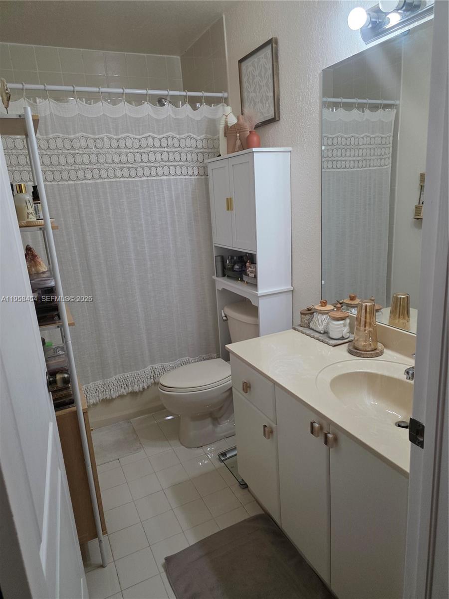 7701 West 36th Avenue, Unit 3 Hialeah, FL 33018 - Photo 16 of 28 a bathroom with a sink toilet and shower