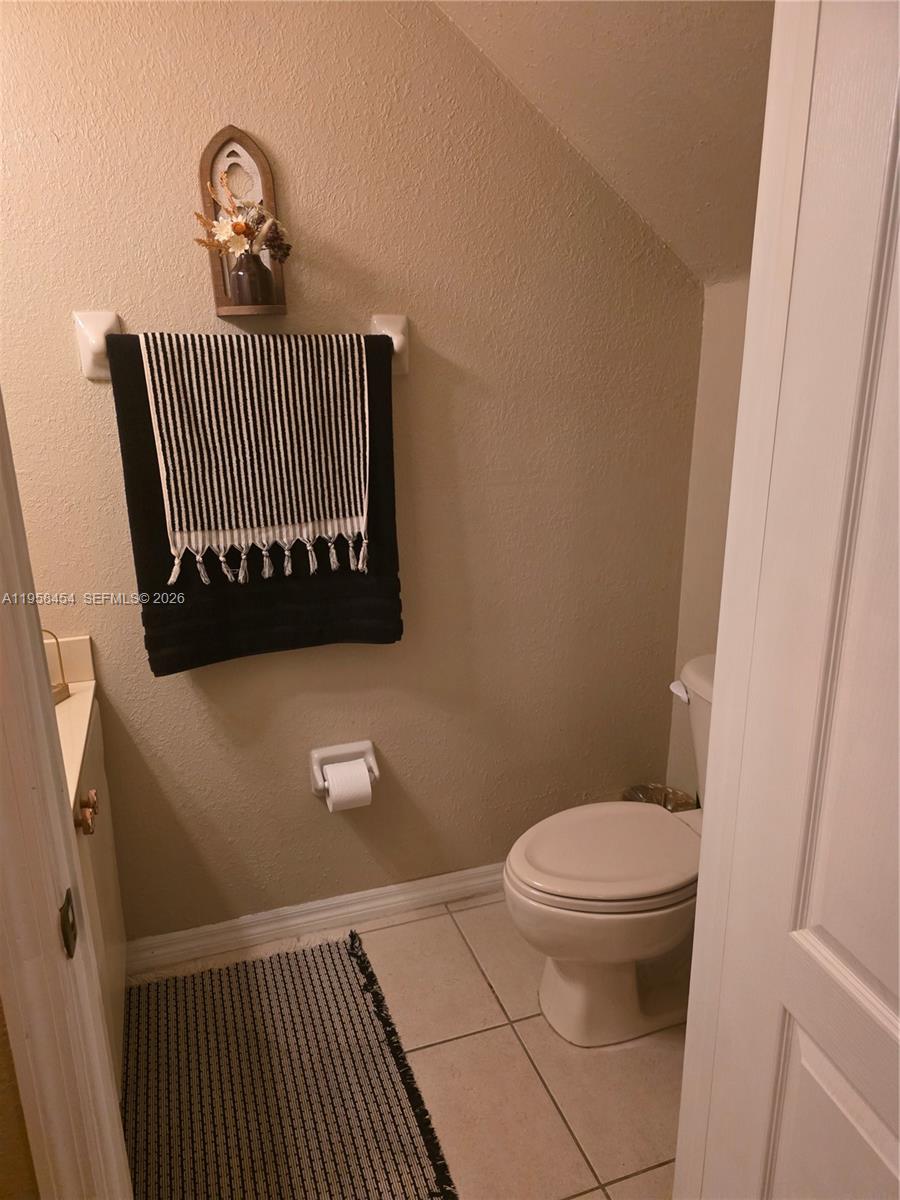 7701 West 36th Avenue, Unit 3 Hialeah, FL 33018 - Photo 20 of 28 a view of a toilet room and wooden floor