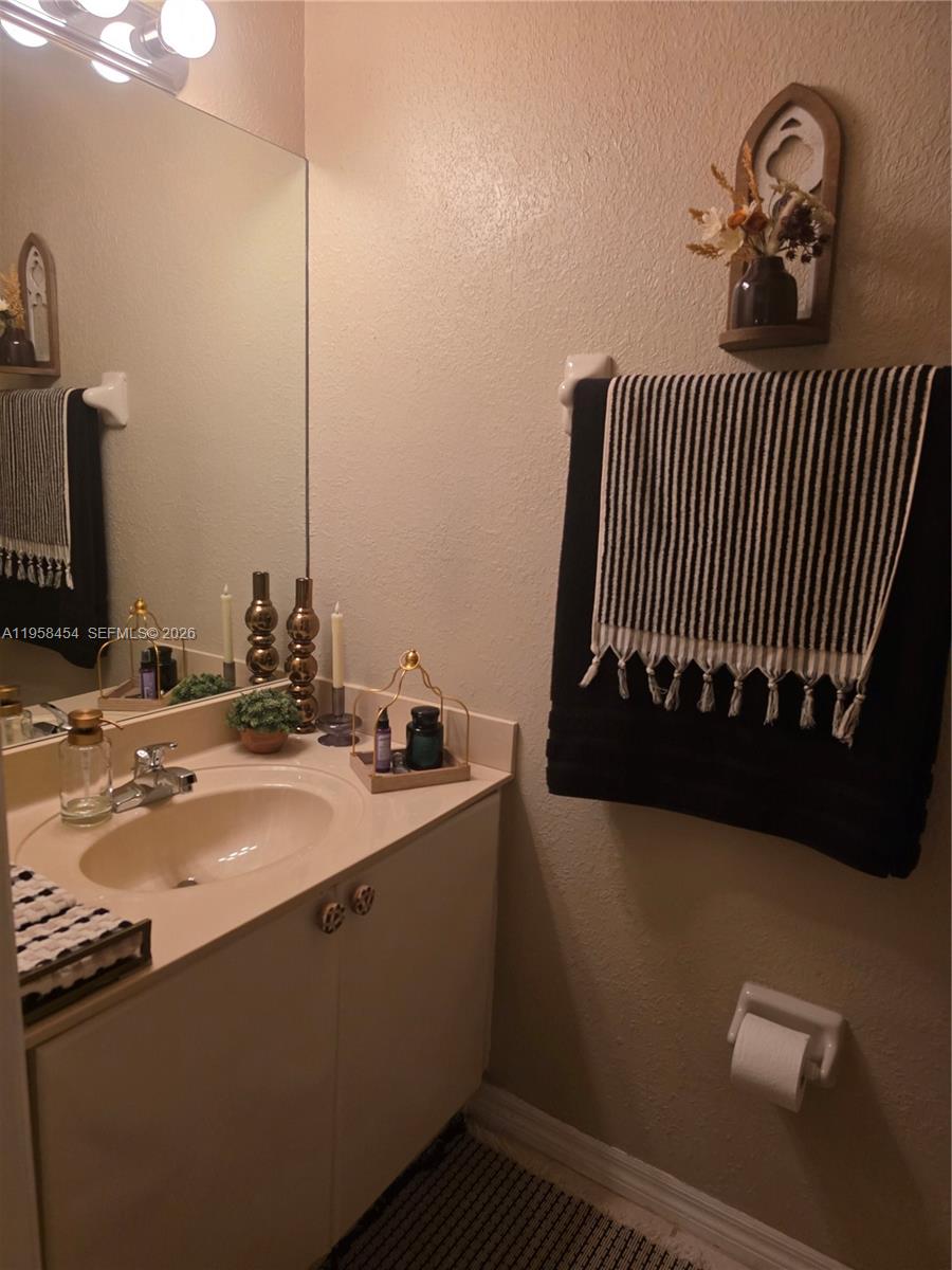 7701 West 36th Avenue, Unit 3 Hialeah, FL 33018 - Photo 21 of 28 a bathroom with a sink and a mirror