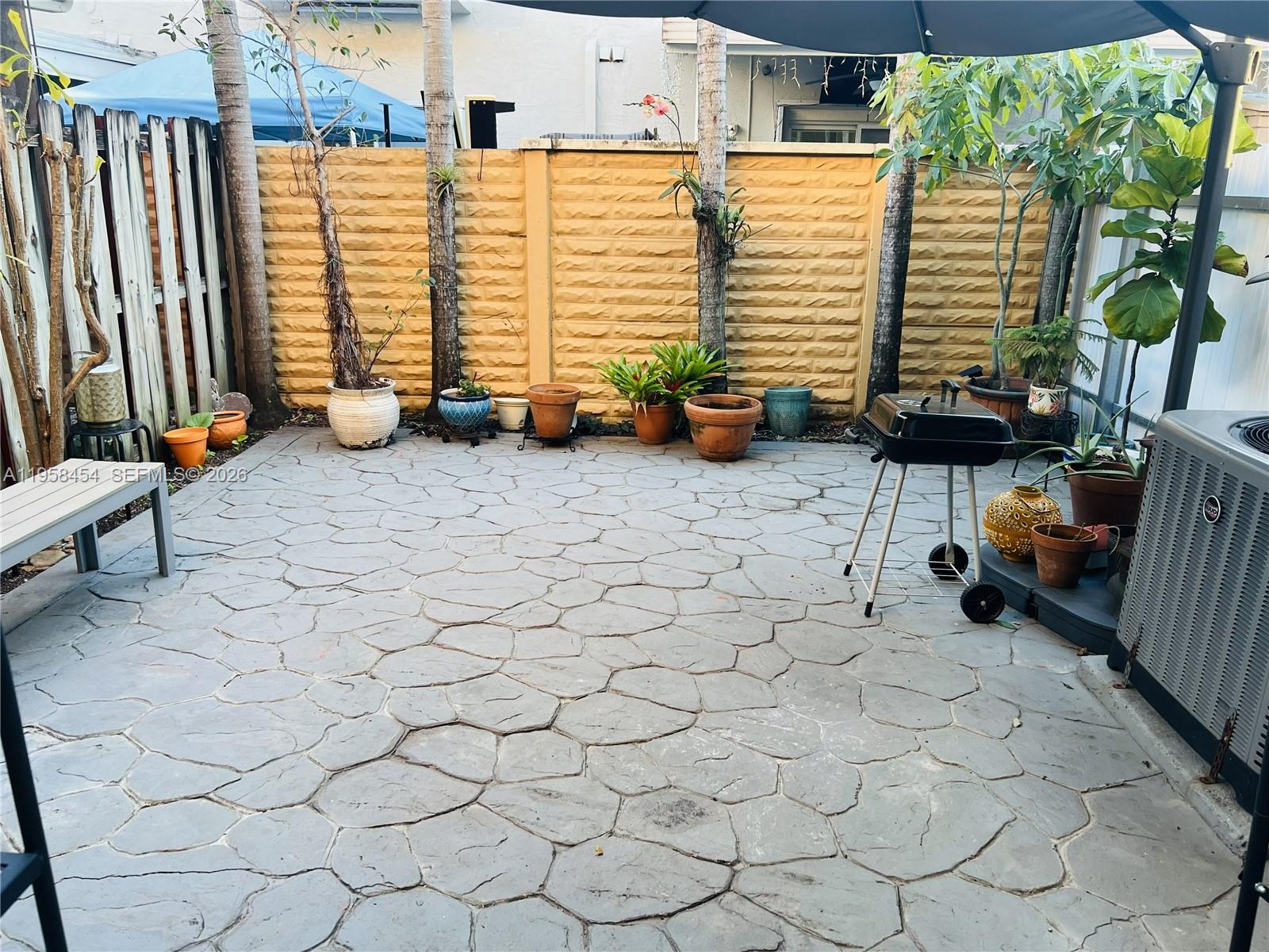 7701 West 36th Avenue, Unit 3 Hialeah, FL 33018 - Photo 27 of 28 a view of a chairs and tables in back yard of the house
