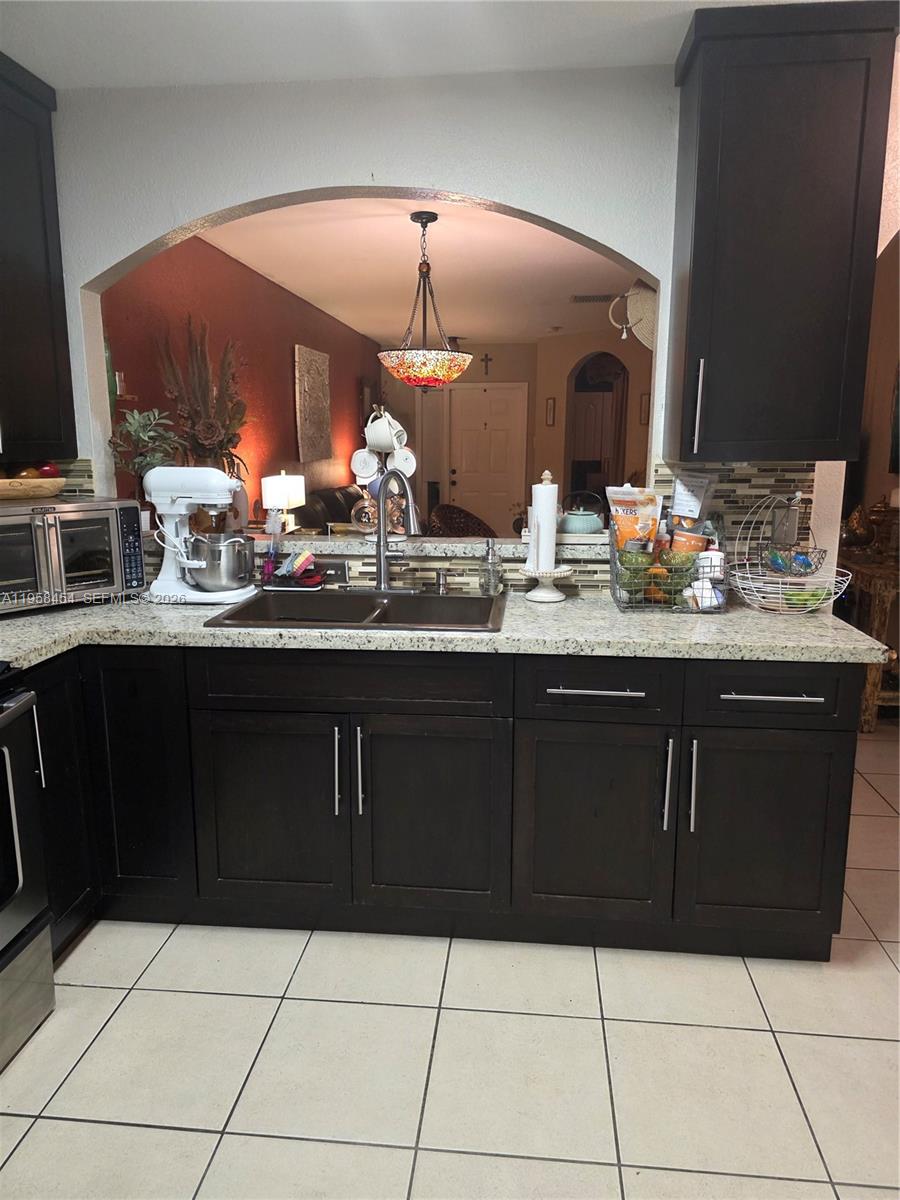 7701 West 36th Avenue, Unit 3 Hialeah, FL 33018 - Photo 8 of 28 a kitchen with a sink and cabinets