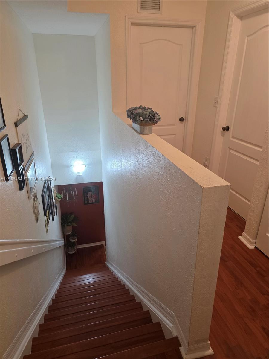 7701 West 36th Avenue, Unit 3 Hialeah, FL 33018 - Photo 10 of 28 a view of a hallway with wooden floor