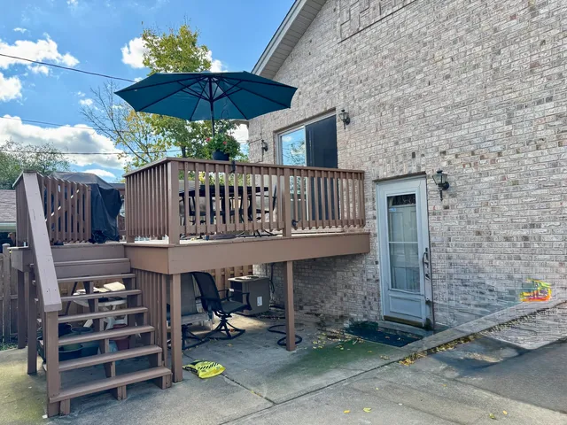 a view of a chairs and table in the back yard of the house