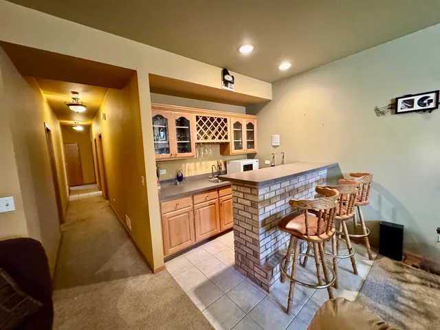 a kitchen with stainless steel appliances kitchen island granite countertop a table and chairs in it