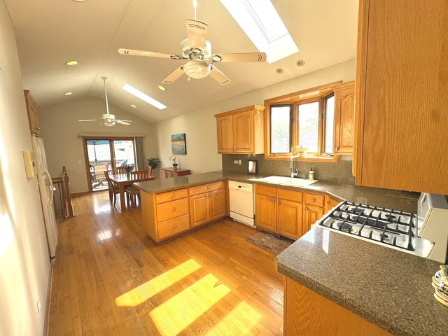 a large white kitchen with a large window