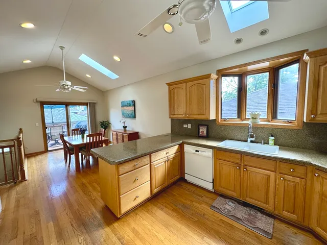 a large white kitchen with lots of counter space a sink and appliances