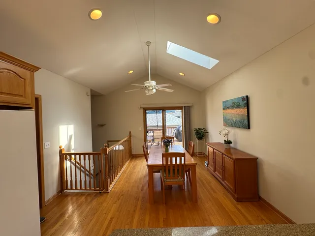 a dining room with furniture and wooden floor