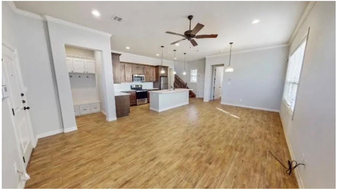 311 Fairway Drive, Unit A Bryan, TX 77801 - Photo 5 of 10 a large room with chandelier fan and wooden floor