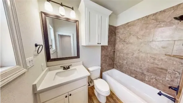 a bathroom with a sink toilet and shower