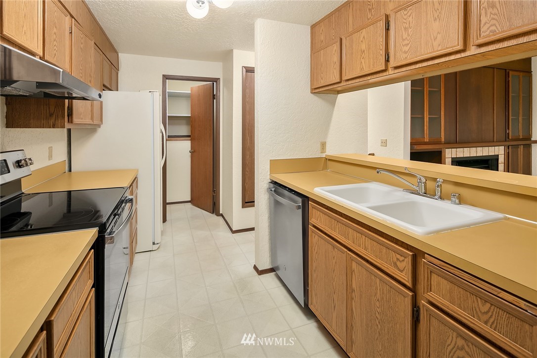 1523 Eagle Ridge Drive South, Unit 1N Renton, WA 98055 - Photo 2 of 21 a utility room with cabinets washer and dryer